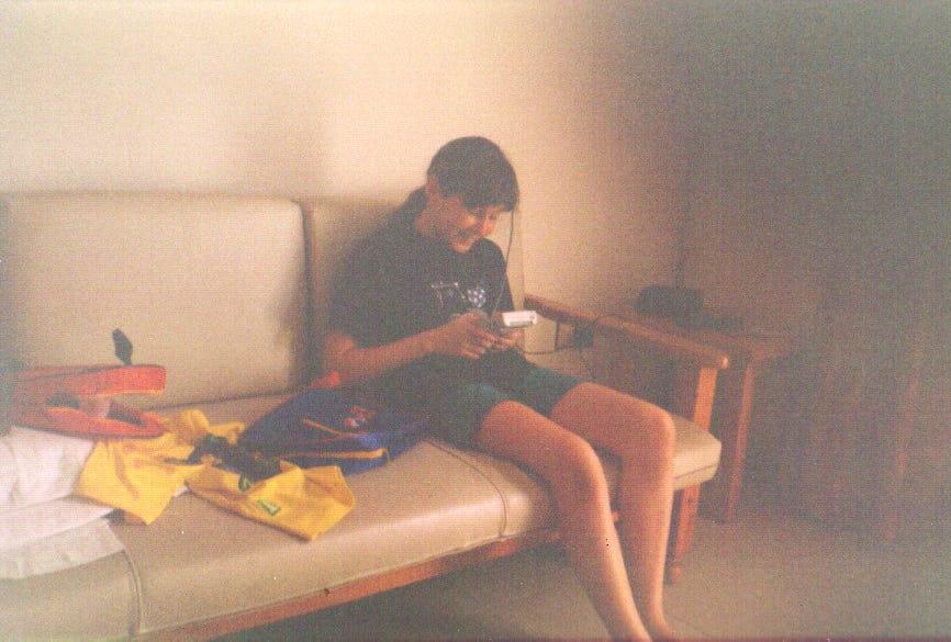 Rachael pictured here on holiday in Spain in the 2000s enjoying Pokémon Yellow on her original Game Boy. She told us that she believes it was a bootleg copy of the game due to it being grey, but had no idea at the time!