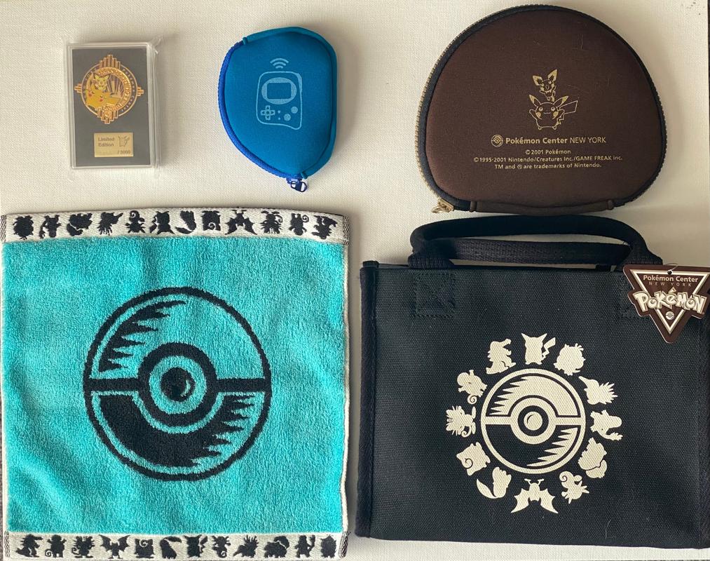 Tatton shared some of the items he still owns from his visit to the Pokémon Center New York store, including a Grand Opening pin badge (0293/3000), Game Boy Advance and Pokémon Mini protective cases, a Poké Ball towel, and a bag which still has its original tag